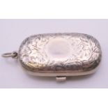 A Victorian silver sovereign case with leaf chased pattern, Birmingham 1886. 6 cm wide. 40 grammes.