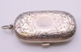 A Victorian silver sovereign case with leaf chased pattern, Birmingham 1886. 6 cm wide. 40 grammes.