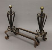 A pair of 19th century brass and iron fire dogs. 46 cm high.