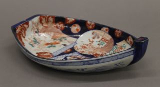 A boat shaped Imari dish hand painted with fishes, flowers, etc. 28 cm long.
