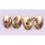 A pair of 18 ct gold, diamond and sapphire cufflinks. 1.75 cm high. 10.1 grammes total weight.