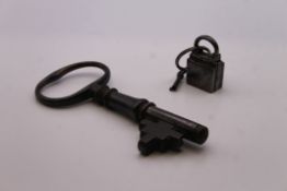 An antique square padlock and a large key. The latter 13 cm long.