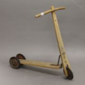 A vintage child's wooden scooter. 63 cm long.