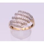 A 9 ct gold four band diamond ring. 17 mm x 15 mm. Ring size S. 3.9 grammes total weight.