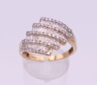 A 9 ct gold four band diamond ring. 17 mm x 15 mm. Ring size S. 3.9 grammes total weight.