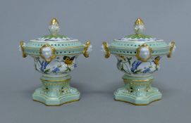 A pair of porcelain pot pourri. 13 cm high.