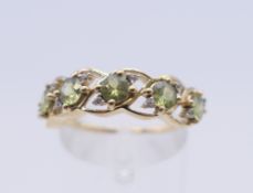 A 9 ct gold peridot ring. Ring size N/O. 2.3 grammes total weight.