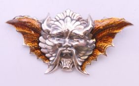 A silver Devil brooch. 5 cm wide.