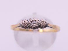 A Victorian 18 ct gold three stone diamond ring. Ring size R. 2 grammes total weight.