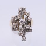 A 9 ct gold diamond set contemporary ring. Ring size N/O. 8.5 grammes total weight.