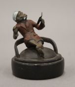 A cold painted bronze model of a smoking monkey mounted on a plinth base. 6.5 cm high.