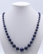 A string of lapis beads. 64 cm long.