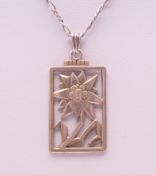 An Art Deco silver Edelweiss Flower pendant stamped 935, on chain. The pendant 3.5 cm high.