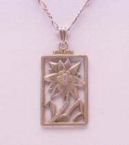 An Art Deco silver Edelweiss Flower pendant stamped 935, on chain. The pendant 3.5 cm high.