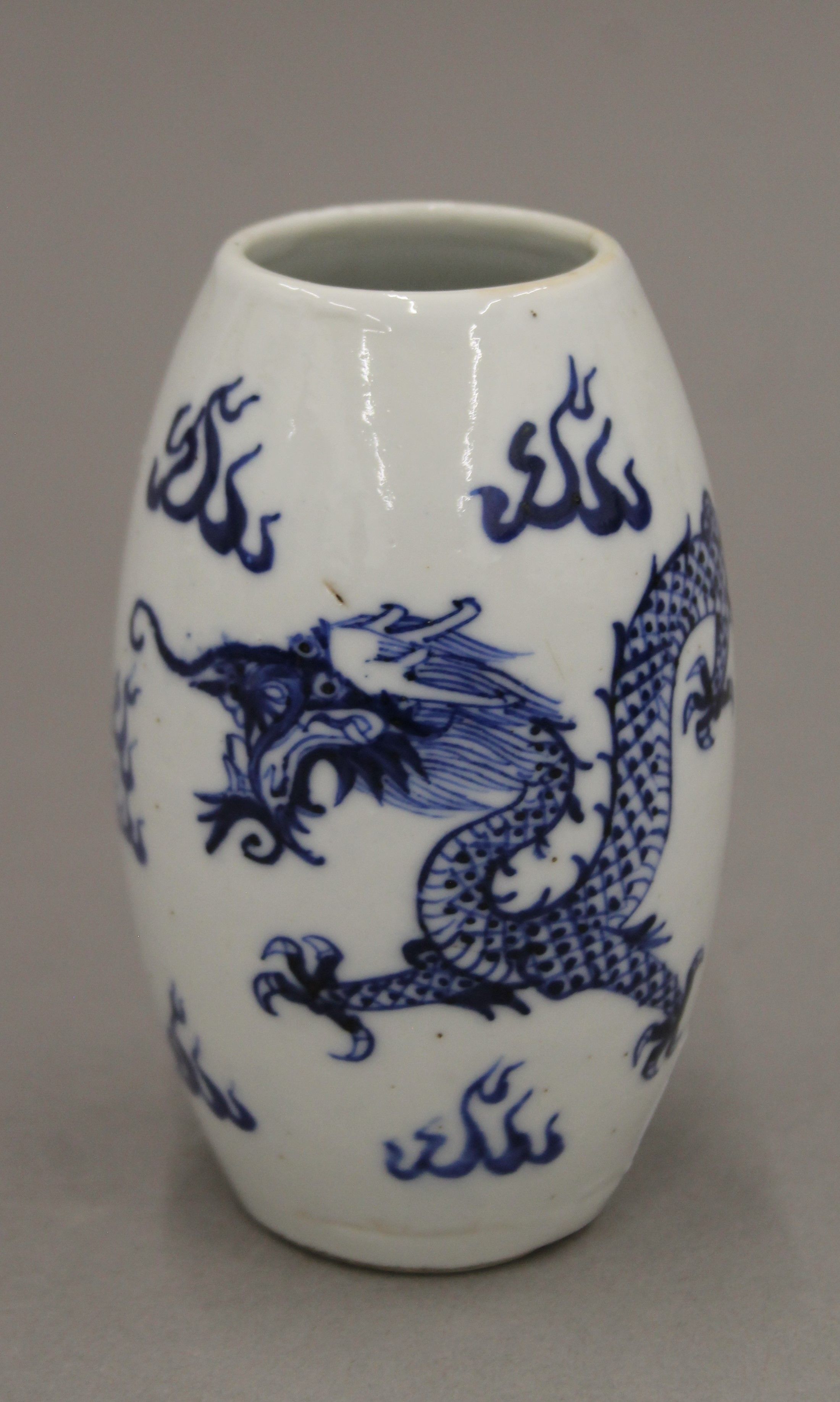 A small Chinese blue and white porcelain vase decorated with four claw dragon,