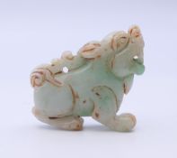 A small two tone jade dog of fo. 4.5 cm long.