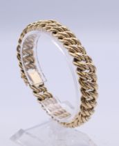 A 9 ct gold bracelet for twisted form. 19 cm long. 22.5 grammes.