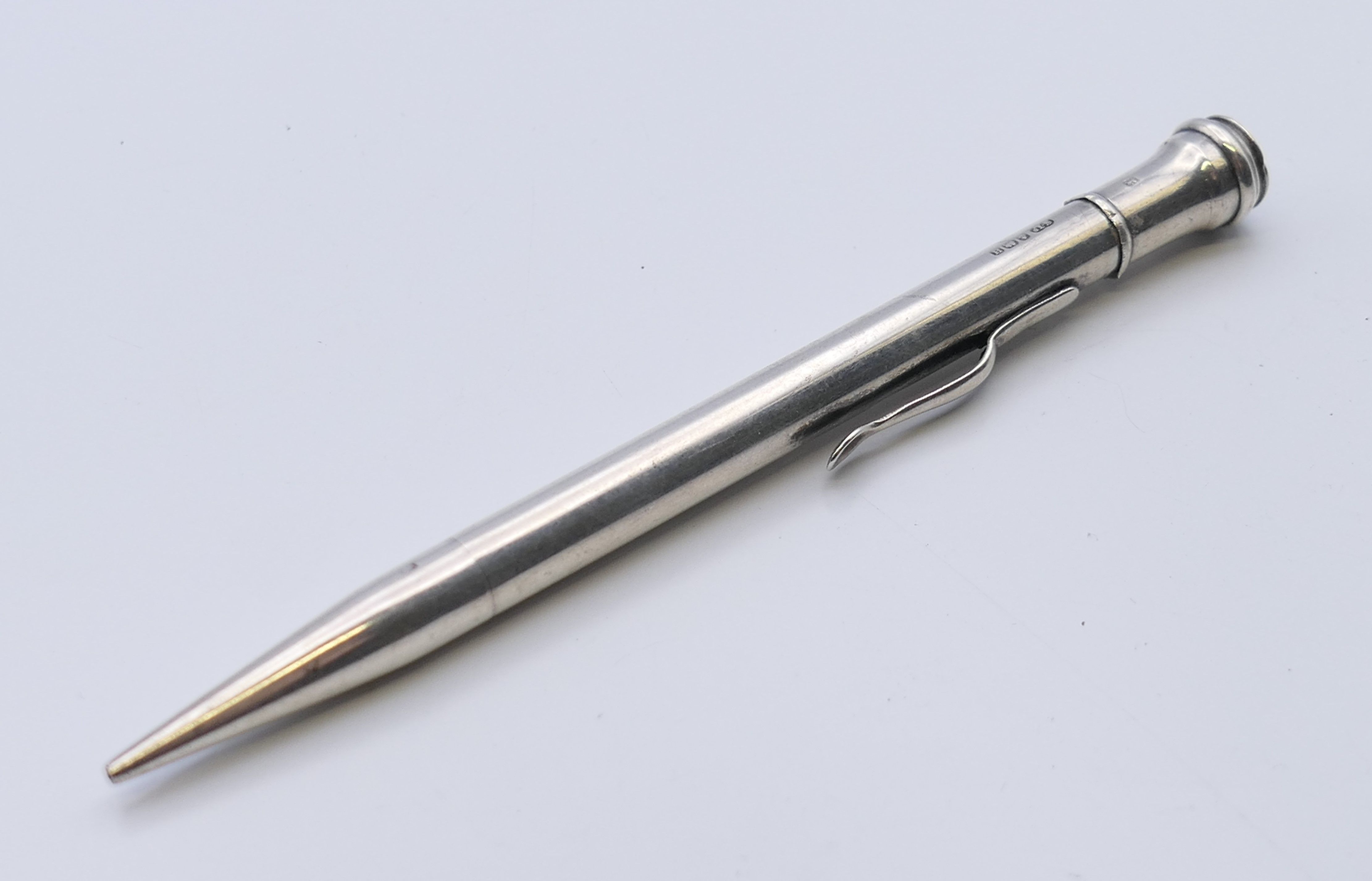 A silver propelling pencil, hallmarked Birmingham 1932. 12 cm long.
