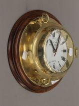 A brass bulk head type clock. 26 cm diameter.