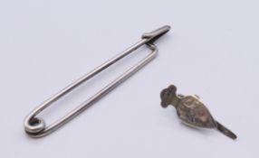 A silver napkin clasp, hallmarked for 1908 and a silver kilt pin. The former 2.5 cm high.