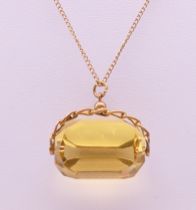 A 9 ct gold mounted citrine pendant on chain. 2.5 cm wide. 10.8 grammes total weight.