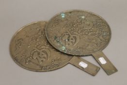 Two Japanese bronze hand mirrors. Each 32 cm high.