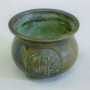 An Arabic bronze censer. 12.5 cm diameter.