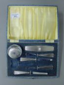 A cased Art Deco silver manicure set (lacking scissors). The case 21.5 cm wide.