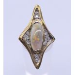 An 18 ct gold abstract opal and diamond ring. Ring size N/O. 3.5 cm high.