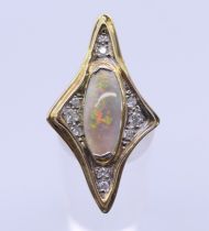 An 18 ct gold abstract opal and diamond ring. Ring size N/O. 3.5 cm high.
