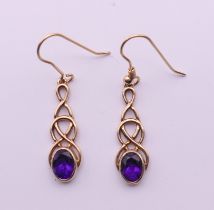 A pair of 9 ct gold and amethyst Celtic rope design earrings. 2.5 cm high. 3.3 grammes total weight.