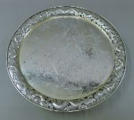A Chinese silver tray, the pierced border decorated with dragons chasing a flaming pearl.