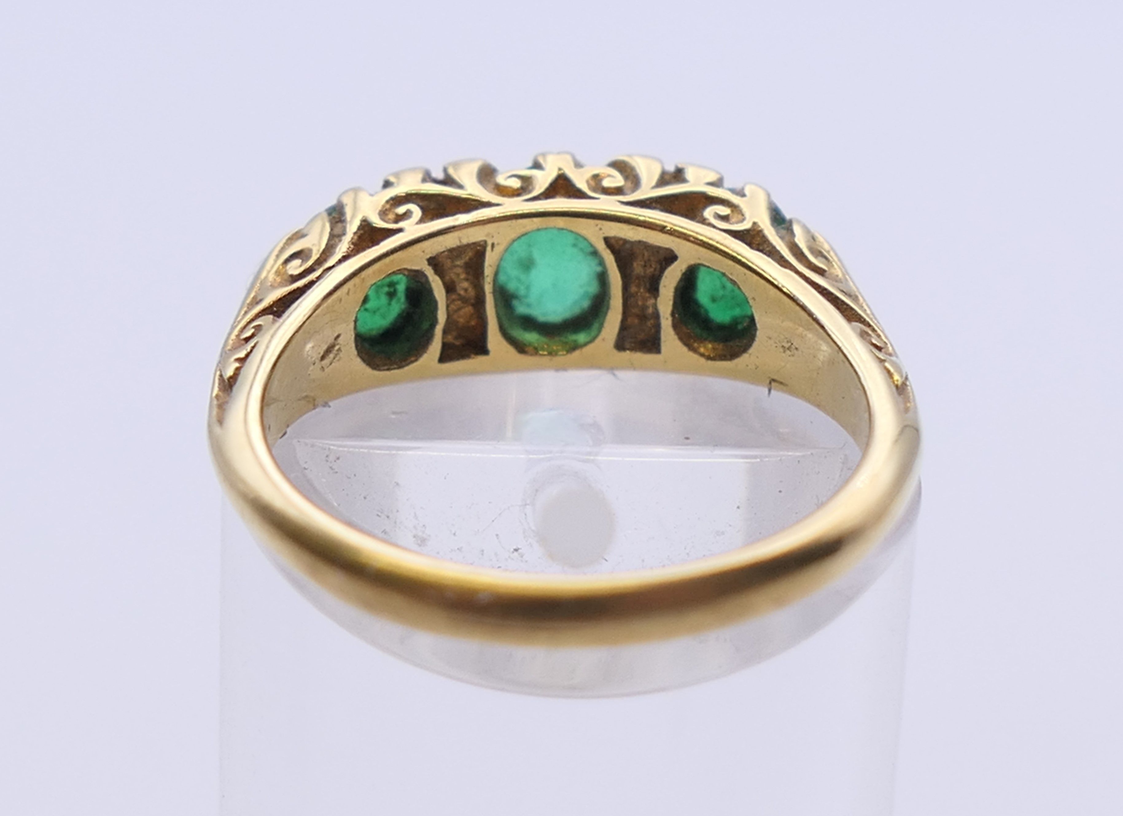 An unmarked gold emerald and diamond ring. Ring size L. 5 grammes total weight. - Image 4 of 5