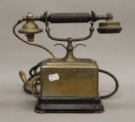 A vintage brass telephone. 25.5 cm high.