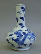 A Chinese blue and white porcelain vase decorated with dragons. 22 cm high.