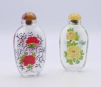 A pair of Chinese glass snuff bottles. Each 8.5 cm high.
