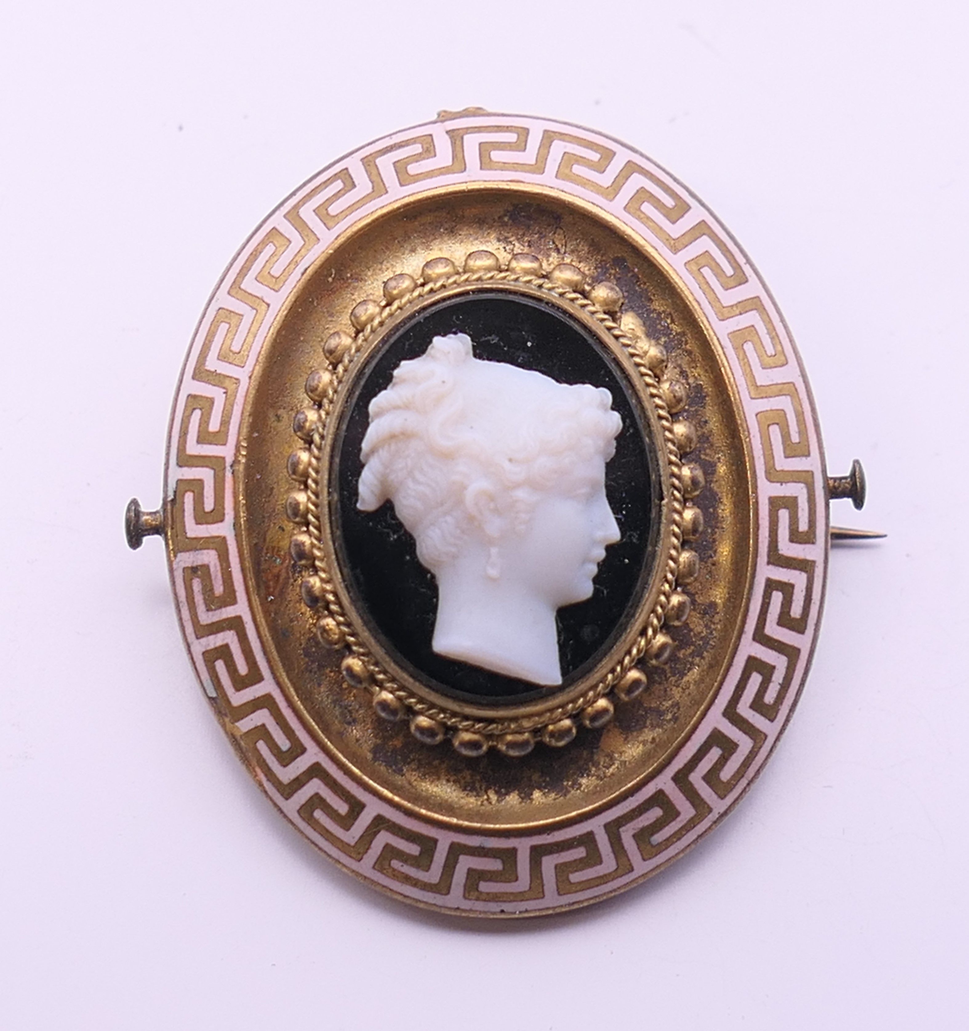 A Victorian enamel and cameo set mourning brooch. 4 cm high.