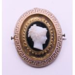 A Victorian enamel and cameo set mourning brooch. 4 cm high.
