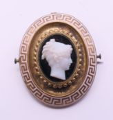 A Victorian enamel and cameo set mourning brooch. 4 cm high.