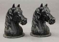 Two black painted cast metal horse head finials. 26.5 cm high.