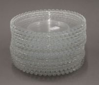 A quantity of glass dessert plates and a glass rolling pin. The former each 18.5 cm diameter.