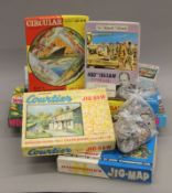 A quantity of vintage jigsaw puzzles, wooden plates, a cuckoo clock and various vintage tins.