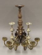 A carved candlestick, a pair of pricket sticks and a pair of wall sconces. The former 50 cm high.