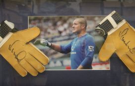 A pair of Goal Keeper gloves, signed by Paul Robinson, housed in a box frame. 66 x 36 cm overall.