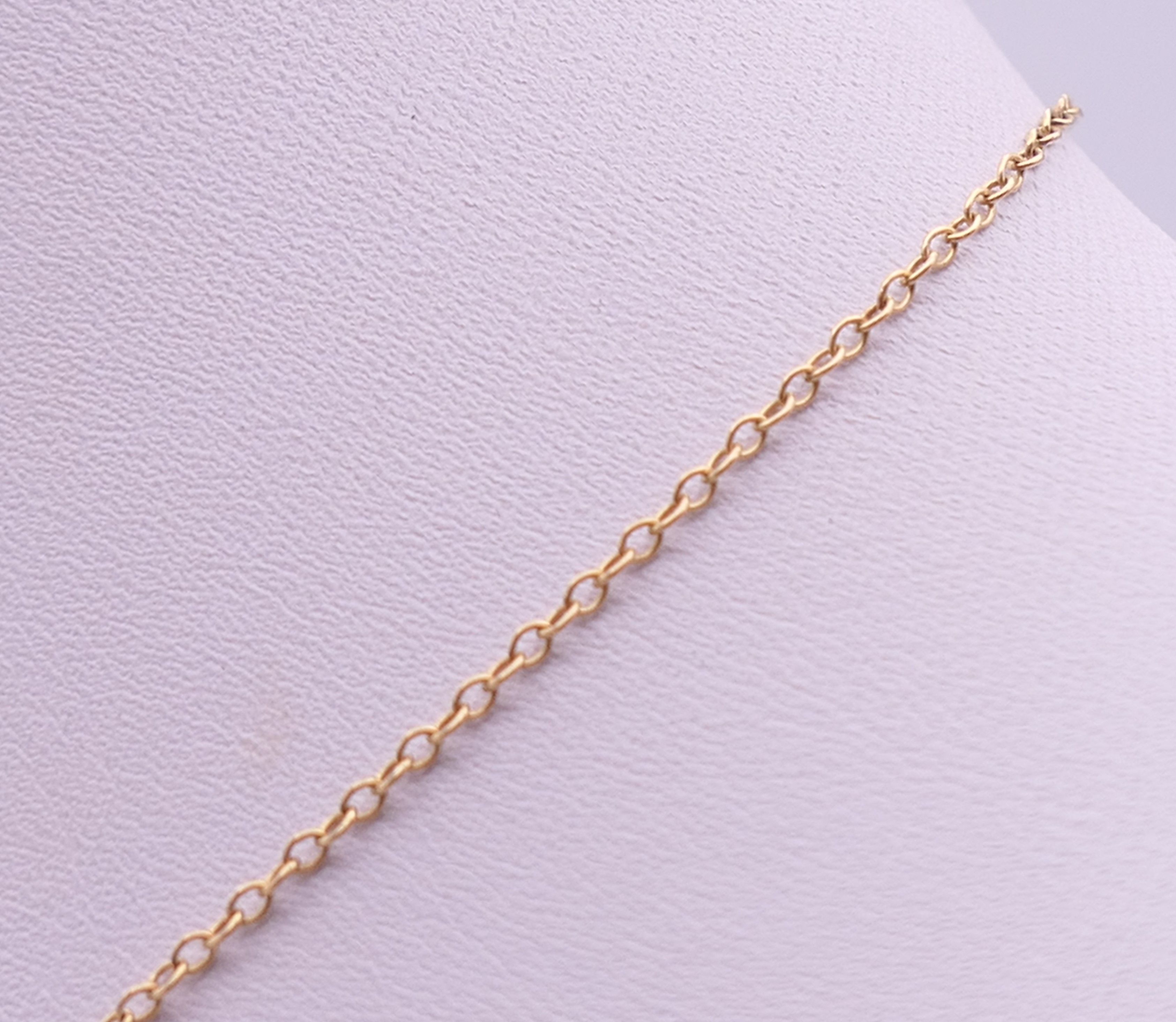 A small 9 ct gold pendant on a 9 ct gold chain. The pendant 1.5 cm high. 1.8 grammes total weight. - Image 3 of 7