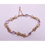 A 9 ct gold amethyst and seed pearl bracelet. 16 cm long. 5.6 grammes total weight.