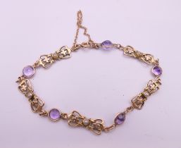 A 9 ct gold amethyst and seed pearl bracelet. 16 cm long. 5.6 grammes total weight.