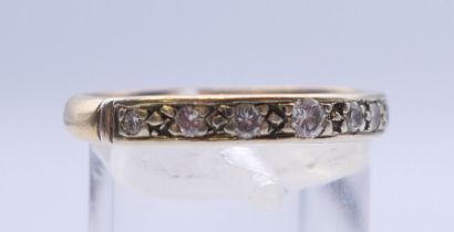 A 9 ct gold diamond half eternity ring. Ring size S/T. 2.7 grammes total weight.