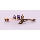 A 9 ct gold amethyst and pearl brooch, makers mark C&S Ltd. 3.5 cm long. 1.6 grammes total weight.