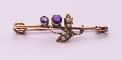 A 9 ct gold amethyst and pearl brooch, makers mark C&S Ltd. 3.5 cm long. 1.6 grammes total weight.